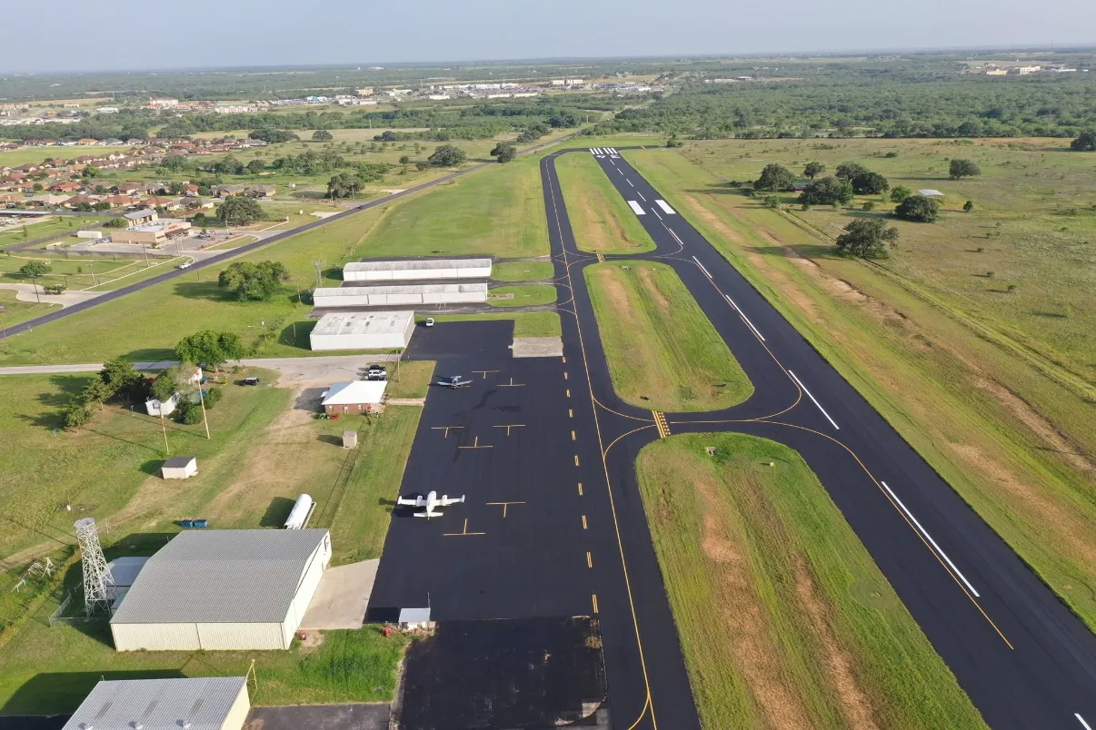 Aerial view of hangars and the runway at Pleasanton Municipal Airport